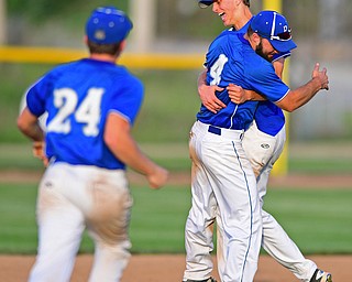 HUDSON, OHIO - MAY27, 2016: Matt Baker #11 of Poland hugs teammate Anthony Calcagni #4 before being tackled by Dan Klase #24 after the final out in the seventh inning of Friday afternoons Division Two Regional Final at the Ballpark at Hudson. Poland won 13-3. DAVID DERMER | THE VINDICATOR