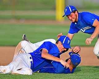 HUDSON, OHIO - MAY27, 2016: Matt Baker #11 of Poland hugs teammate Anthony Calcagni #4 on the ground while Dan Klase #24 jumps on top after the final out in the seventh inning of Friday afternoons Division Two Regional Final at the Ballpark at Hudson. Poland won 13-3. DAVID DERMER | THE VINDICATOR