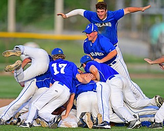 HUDSON, OHIO - MAY27, 2016: Pad O'Shaughnessy #21 of Poland leaps on top of the dog pile of Poland players after the final out in the seventh inning of Friday afternoons Division Two Regional Final at the Ballpark at Hudson. Poland won 13-3. DAVID DERMER | THE VINDICATOR