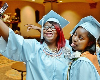 Jeff Lange | The Vindicator  FRI, MAY 27, 2016 - East High graduates Jaziya Abrams (left) and Zaria Love pose for a selfie prior to the start of Friday morning's commencement at Stambaugh Auditorium.