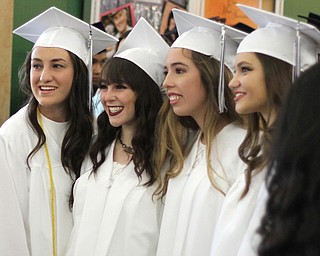 Nikos Frazier | The  Vindicator.(left to right) Ellie Cole, Maria Stroup, Marley Cuckovich, and Abigail Roberts smile as their family members take photos before John F. Kennedy Catholic School's 51st annual commencement at Packard Music Hall.
