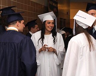 Nikos Frazier | The  Vindicator..Mackayla Kroll(center) talks with her classmates from John F. Kennedy Catholic School before entering Packard Music Hall to receive her diploma.