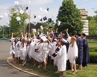 Nikos Frazier | The  Vindicator..John F. Kennedy Catholic School's class of 2016 thows their caps in the air after recieveing their diplomas outside of Packard Music Hall in Warren.