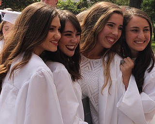 Nikos Frazier | The  Vindicator.(left to right) Abigail Roberts , Maria Stroup, Marley Cuckovich, and Ellie Cole smile as their family members take photos after recieving their diplomas from John F. Kennedy Catholic School in Packard Music Hall.