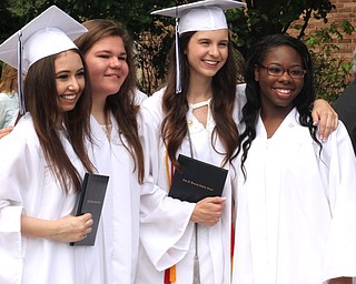 Nikos Frazier | The  Vindicator.(left to right) Natalie Rappach, McKenzie Shiamone, Erin Walsh and Ta'Zyare Spicer smile as their family members take photos after recieving their diplomas from John F. Kennedy Catholic School oustside Packard Music Hall.
