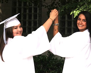 Nikos Frazier | The  Vindicator.Grace Flajnik(left) and MacKayla Kroll(right) hold hands outside of Packard Music Hall after recieving their diplomas from John F. Kennedy Catholic School on Saturday, May 28, 2016.