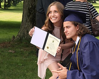 Nikos Frazier | The  Vindicator..Nathan Hoso(right) poses with Natalie Hoso(left) outside of Packard Music Hall in Warren after Nathan revieved his diploma from John F. Kennedy Catholic School.