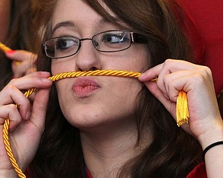 Nikos Frazier | The  Vindicator.Alyssa Scarpaci plays with her cords before walking in to Packard Music Hall to recieve her diploma from Niles McKinley High School.