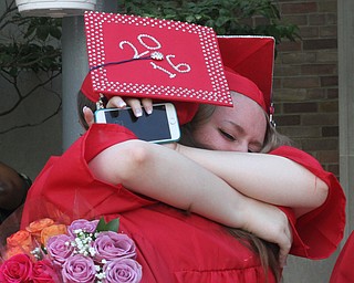 Nikos Frazier | The  Vindicator.Sam Lashley embraces Jacklyn Rowley outside of Packard Music Hall after the two became graduates of Niles McKinley High School.