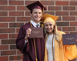 Nikos Frazier | The  Vindicator.Cole Frank(left) and Madalyn Baker(right) pose for photos after receiving their diplomas from South Range High School on Saturday, May 28, 2016.