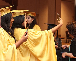 Nikos Frazier | The Vindicator..Destiny love(left) and Brandi Lambert(right) take a selfie in Stambaugh Auditorium before receiving their diplomas from Cardinal Mooney High School.