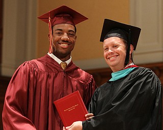 Nikos Frazier | The Vindicator..Aaron Woodberry receives his Cardinal Mooney High School diploma from Principal Mark Vollmer.