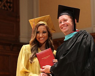 Nikos Frazier | The Vindicator..Cia Lyras receives her Cardinal Mooney High School diploma from Principal Mark Vollmer.