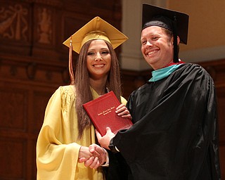 Nikos Frazier | The Vindicator..Lexy Herman receives her Cardinal Mooney High School diploma from Principal Mark Vollmer.