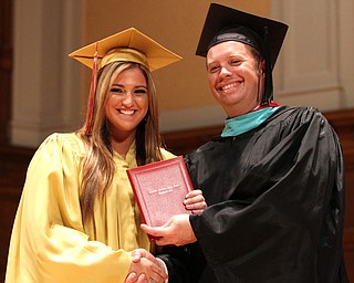 Nikos Frazier | The Vindicator..Julie Cook receives her Cardinal Mooney High School diploma from Principal Mark Vollmer.