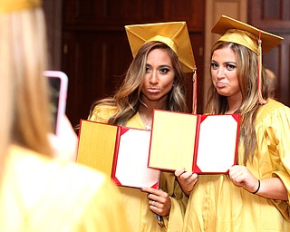 Nikos Frazier | The Vindicator..Cia Lyras(left) poses with Julie Cook(right) with empty diplomas after graduating from Cardinal Mooney High School on Sunday, May 29, 2016.