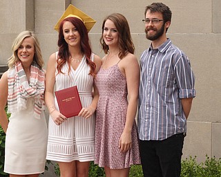 Nikos Frazier | The Vindicator..(left to right) Jayne Dimascio, Anne Alcorn, Emily Alcorn and Joe Alcorn pose for photos outside of Stambaugh Auditorium after Anne Alcorn graduated from Cardinal Mooney High School.