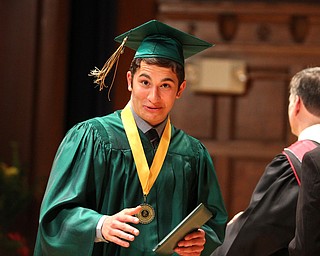 Nikos Frazier | The Vindicator..Anthony Morgione walks off stage after receiving his diploma from Ursline High School.