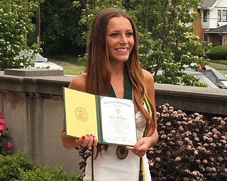 Nikos Frazier | The Vindicator..Sidney Parks holds up her Ursline High School diploma outside of Stambaugh Auditorium.