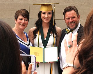 Nikos Frazier | The Vindicator..Erica Lehn(center) poses with her parents, Alexandria Rossetti(left) and William Lehn(right) outside of Stambaugh Auditorium after graduation from Ursline High School.