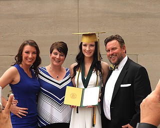 Nikos Frazier | The Vindicator..(left to right) Victoria Lehn, Erica Lehn, Alexandria Rossetti and William Lehn pose for pictures outside of Stambaugh Auditorium after Erica received her diploma from Ursline High School.
