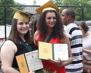 Nikos Frazier | The Vindicator..Maura Rubinic(left) and Angelica Kratzer(right) pose for pictures outside of Stambaugh Auditorium after graduating from Ursline High School.