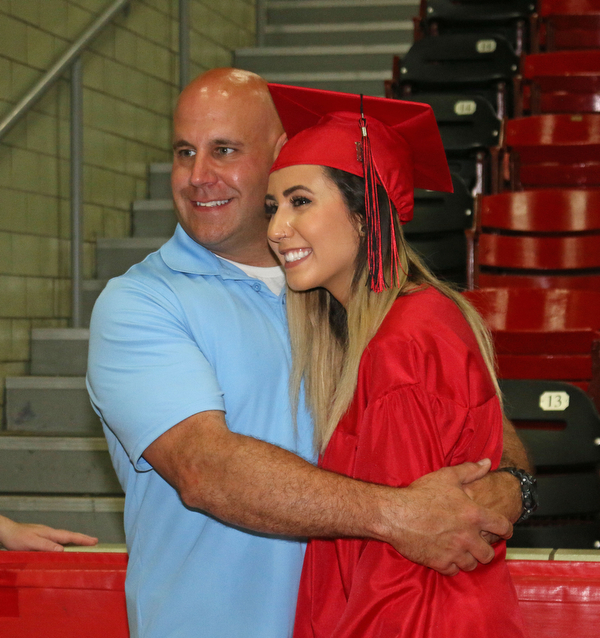Robert Vukovich (left) hugs his daughter Alexis Vukovich (right) while taking a picture after she received her diploma during the Struthers High School Commencement on Sunday afternoon.   Dustin Livesay   |   The Vindicator 5/29/16  Struthers High School