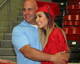 Robert Vukovich (left) hugs his daughter Alexis Vukovich (right) while taking a picture after she received her diploma during the Struthers High School Commencement on Sunday afternoon. Dustin Livesay | The Vindicator 5/29/16 Struthers High School