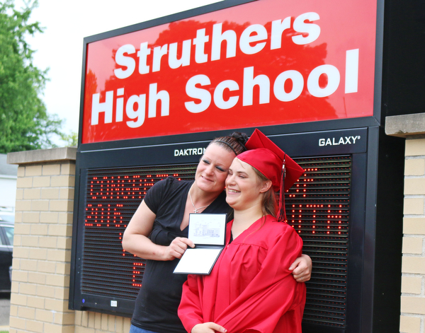 Sabrina Welce (right) poses for a picture in front of the Struthers High School sign with her mother Kelly Bucker after the Struthers High School Commencement on Sunday afternoon.  Dustin Livesay  |  The Vindicator  5/29/16  Struthers High School.