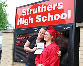 Sabrina Welce (right) poses for a picture in front of the Struthers High School sign with her mother Kelly Bucker after the Struthers High School Commencement on Sunday afternoon. Dustin Livesay | The Vindicator 5/29/16 Struthers High School.
