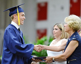 Jeff Lange | The Vindicator SUN, MAY 29, 2016 - Andrew Green (left) shakes hands with Kathy Mock as he receives his diploma during Sunday's commencement at Austintown Fitch High School.