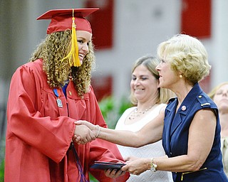 Jeff Lange | The Vindicator SUN, MAY 29, 2016 - Bella Caruso (left) shakes hands with Kathy Mock as she receives her diploma during commencement at Austintown Fitch High School on Sunday.