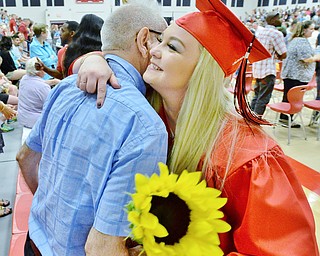 Jeff Lange | The Vindicator SUN, MAY 29, 2016 - Taylor Schlatter (facing) hugs Ralph Funaro of Girard after Sunday's commencement at Girard High School. Schlatter has known Ralph since childhood when his wife, Joan, babysat her.