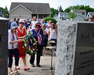 STRUTHERS, OHIO - MAY 30, 2016: (LtoR) Katie Armstrong from VFW Post 3538, Jan Brown from AMVETS Post 44, and Arleen Arendas from VFW Post 7538 place a commemorative wreath in front of a new memorial Monday morning during a fallen soldier memorial dedication at Struthers High School. DAVID DERMER | THE VINDICATOR