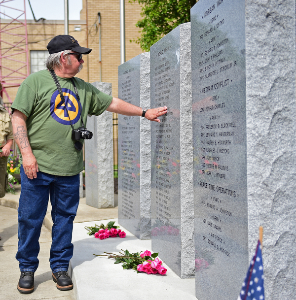 STRUTHERS, OHIO - MAY 30, 2016: Mike Goskie of Struthers touches the name of his uncle PFC Michael C. Goskie, who was killed in action in World War Two, Monday morning during a fallen soldier memorial dedication at Struthers High School. DAVID DERMER | THE VINDICATOR