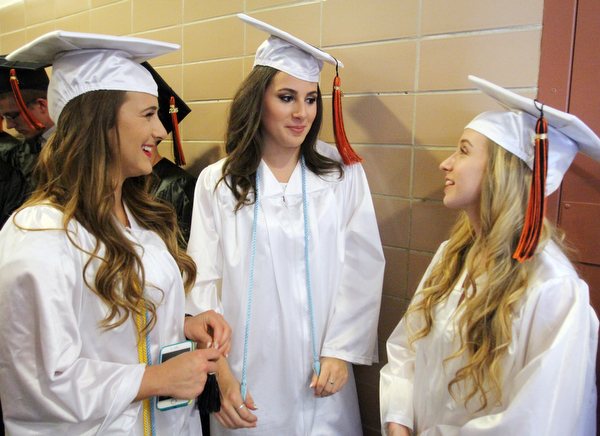 William D. Lewis\The Vindicator.Graduating Howland seniors from left, Nicole Lussier, Reilly Berk and Brenna Barrass share a moment prior to Wednesday June 1, 2016 ceremony at Packard Music Hall in Warren.
