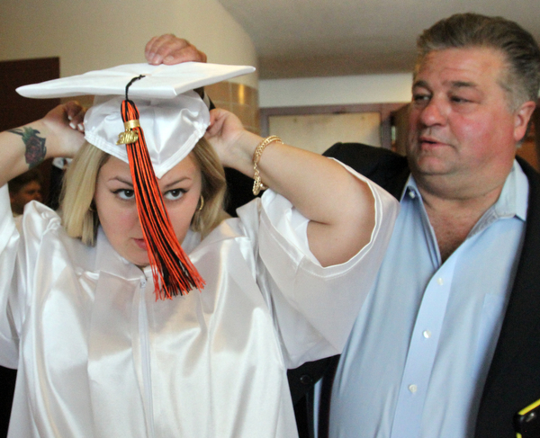 William D. Lewis\The Vindicator Howland graduating senior Danielle Polivka gets some help with her cap from her dad, Dan Polivka, before commencencement Wednesday June1,2016 t Packard Music Hall in Warren..