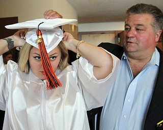 William D. Lewis\The Vindicator Howland graduating senior Danielle Polivka gets some help with her cap from her dad, Dan Polivka, before commencencement Wednesday June1,2016 t Packard Music Hall in Warren..