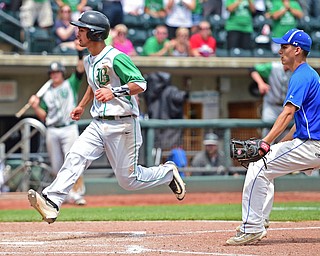 COLUMBUS, OHIO - JUNE 2, 2016: Daunte DeCello #22 of Hamilton Badin flies through the air before stepping on home to score after a pass ball by Don Drummond #13 of Poland in the sixth inning of Thursday afternoons Division Two State Semi-Final game at Huntington Park. Hamilton Badin won 8-3. DAVID DERMER | THE VINDICATOR