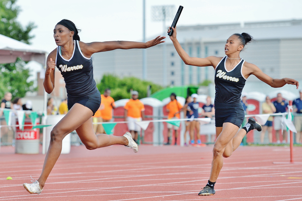 Jeff Lange | The Vindicator  FRI, JUN 3, 2016 - Warren Harding's Aisha Jackson (left) takes the handoff from teammate Gariana Bercheni in the girls 4x100 meter relay during Friday's OHSAA State Track and Field tournament at Jesse Owens Memorial Stadium in Columbus. Harding placed second with a qualifying time of 47.93 seconds.