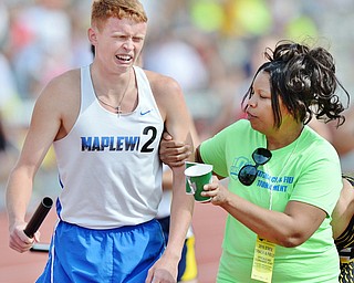 Jeff Lange | The Vindicator  FRI, JUN 3, 2016 - Maplewood's Allen Sparks (left) is walked off the track after he and the Maplewood boys 4x800 team placed second in the 4x800 meter relay race during Friday's OHSAA State Track and Field tournament held at Jesse Owens Memorial Stadium in Columbus.