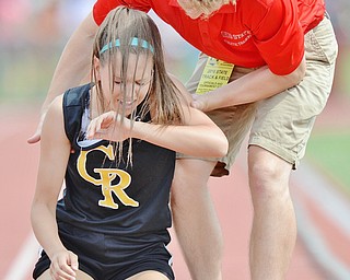 Jeff Lange | The Vindicator  FRI, JUN 3, 2016 - Crestview's Maura Belding is lifted off the track by an OHSAA official after placing last in the first heat of the girls 400 meter dash  during Friday's OHSAA State Track and Field tournament held at Jesse Owens Memorial Stadium in Columbus.