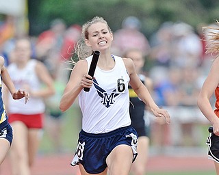 Jeff Lange | The Vindicator SAT, JUN 4, 2016 - McDonald's Malina Mitchell (center) passes Minster's Madeline Magoto (right) in the final 100 meters of the girls 4x400 meter relay as Archibold's Dakota Stamm brings trails behind during Saturday's OHSAA State Track and Field tournament in Columbus.
