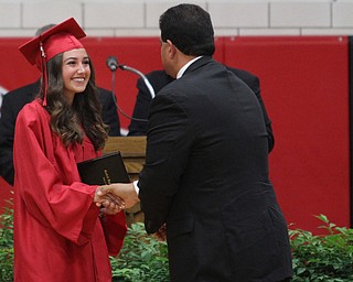 Nikos Frazier | The Vindicator..Alyssa Cross(left) shakes Alex Geordan, Superintendent of Canfield Local Schools, hand after receiving her diploma from Canfield High School.