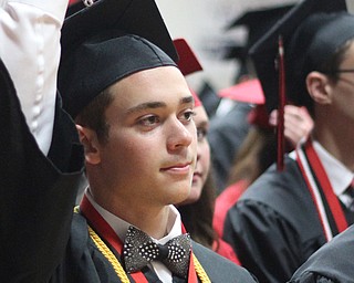 Nikos Frazier | The Vindicator..Will Hume holds his tassel before turning it to his left side during his final moments as a student at Canfield High School.