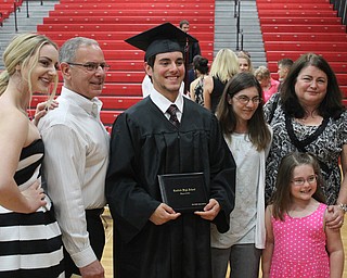 Nikos Frazier | The Vindicator..Mathew Pappas takes photos with his family after graduating from Canfield High School.
