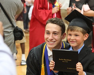 Nikos Frazier | The Vindicator..Troy Williams(left) smiles next to his brother, McCoy Reid, 5, Williams graduated from Canfield High School.
