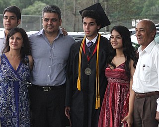 Nikos Frazier | The Vindicator..Arjun Joshi poses with his family outside of Canfield High School after graduating with the class of 2016.