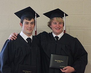 Nikos Frazier | The Vindicator..Alex Schill(left) and Patrick Byrne pose for photos with their families after graduating from Canfield High School.
