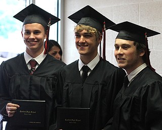 Nikos Frazier | The Vindicator..(left to right) Andrew Griswold, Tyler Young and Trevor Wilson pose for photos with their families after graduating from Canfield High School.